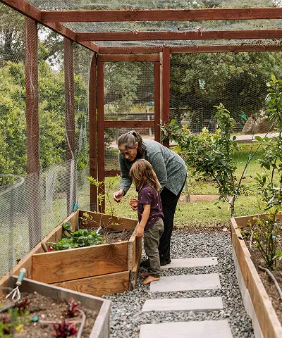 A woman with a child in a garden