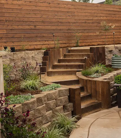 Wooden stairs leading up a block wall