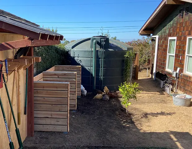 A graywater tank on the side of a house