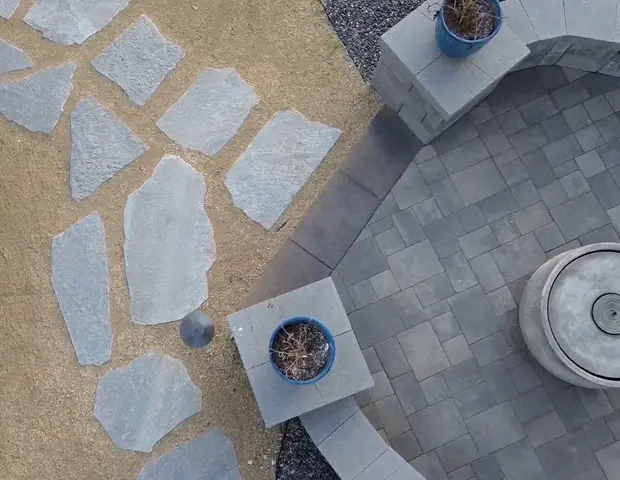 A stone walk way leading up to a firepit