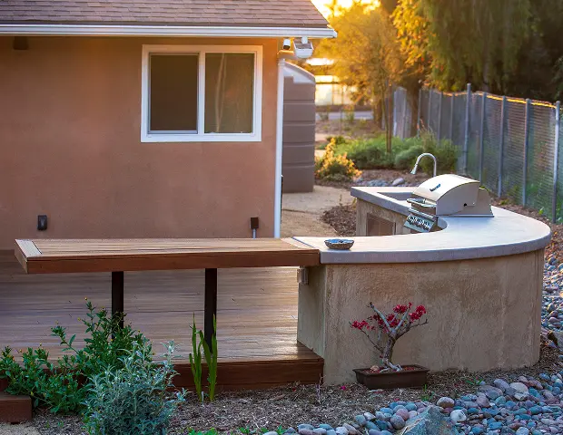 A curved corner setup with a grill built in