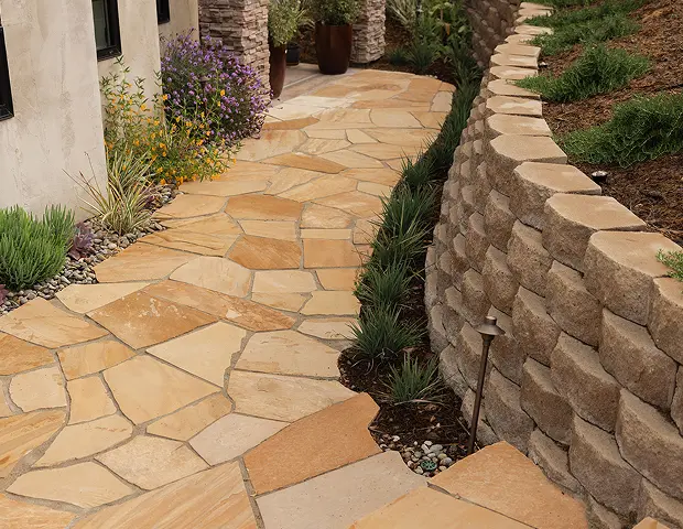 A blocklite wall with a stone walkway paved along it