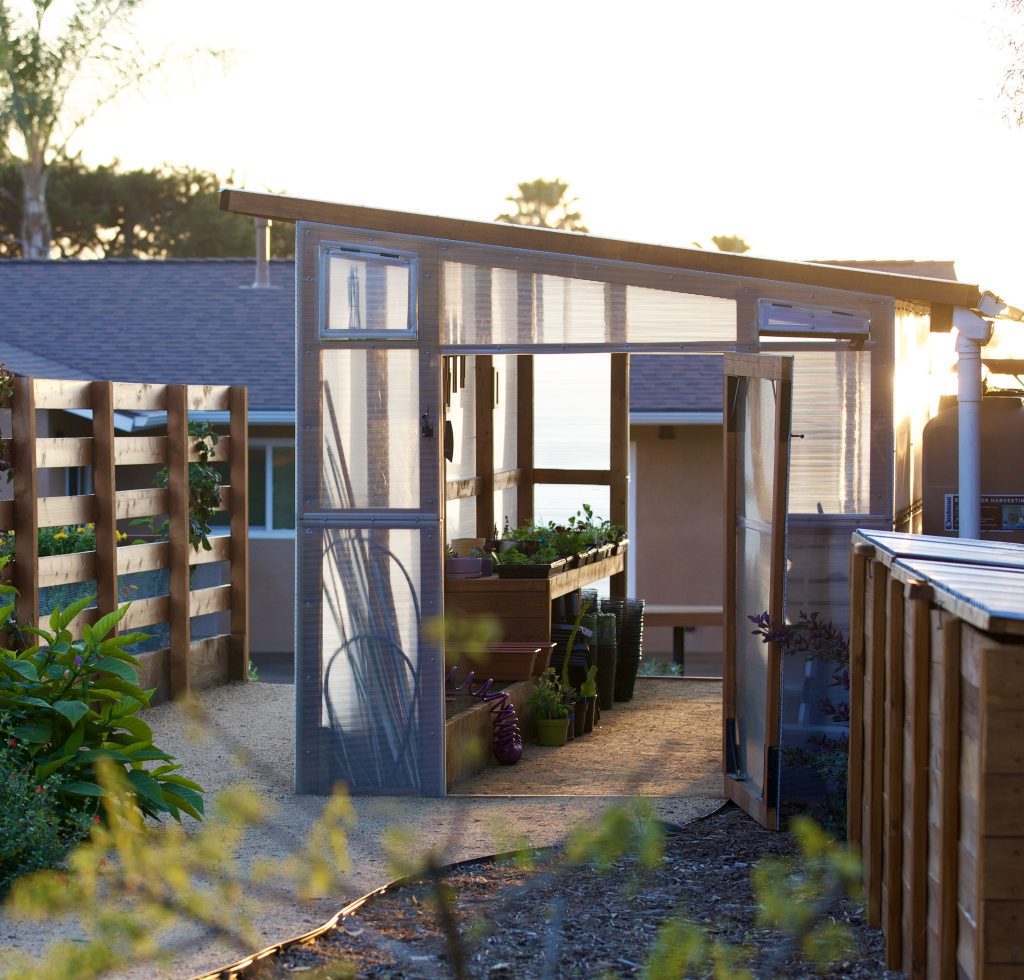 custom greenhouse and a large garden
