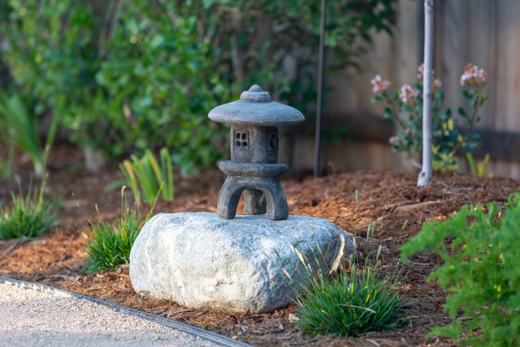 Japanese stone lantern among boulders and plantings