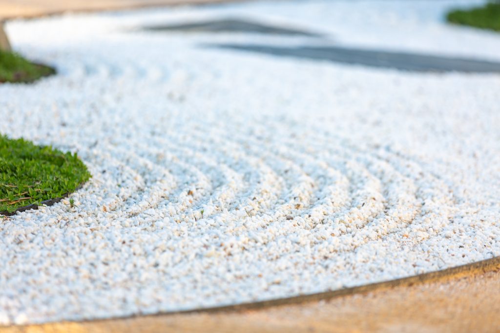 Raked white aggregate in a zen raking pattern