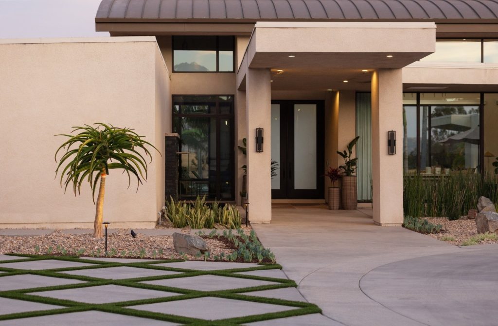 high-end modern home entrance with wood and concrete details