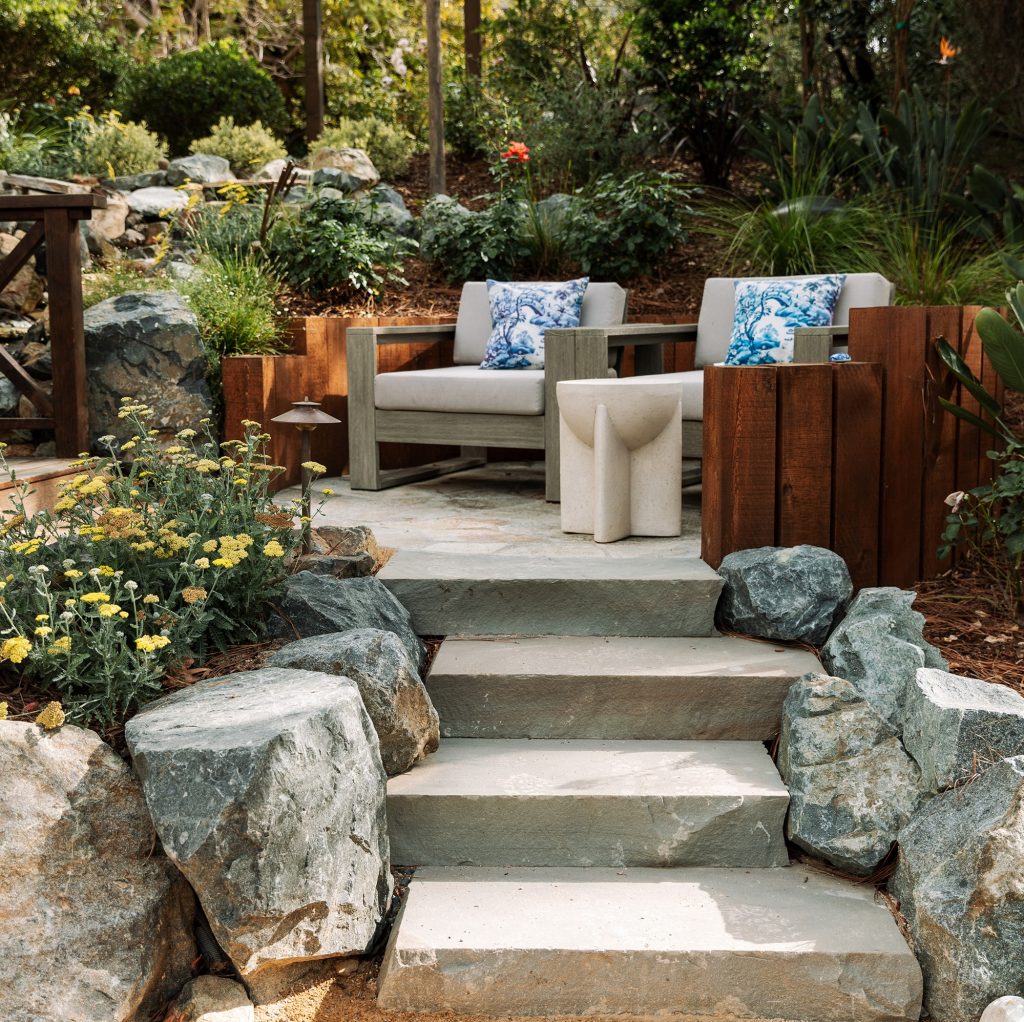 boulder steps and a flagstone patio with timber retaining wall